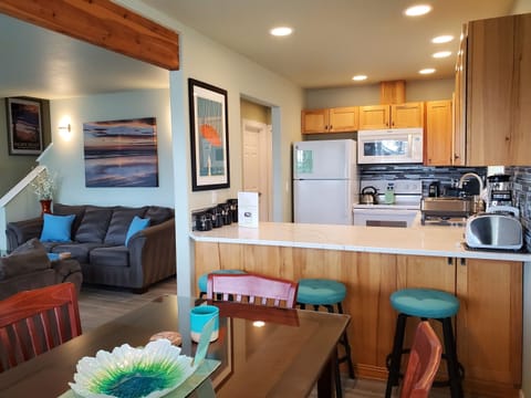 The dining table seats 6 with an additional 3 at the breakfast bar