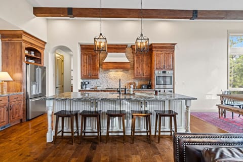 Gather, cook, and connect in this heart-of-the-home gourmet kitchen—where rustic charm meets modern luxury. With high-end appliances, warm wood cabinetry, and a spacious granite island perfect for morning coffee or evening wine, it’s a space made for memo