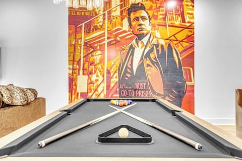 Pool table under a mural wall sets the scene for late-night games and competition. This is where your crew lives before everyone crashes