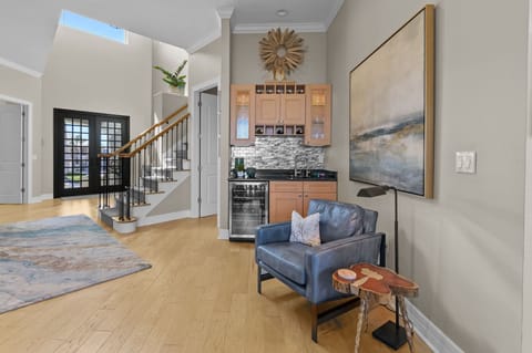 Unwind in plush comfort with a cozy seating area and a stylish wet bar—perfect for relaxing and entertaining.