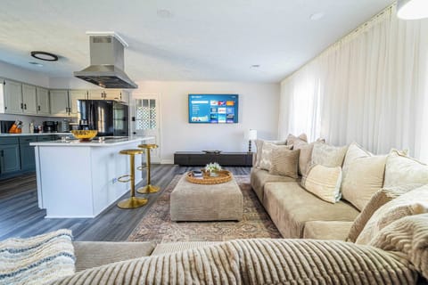 "Spacious living area with a plush sectional sofa."

