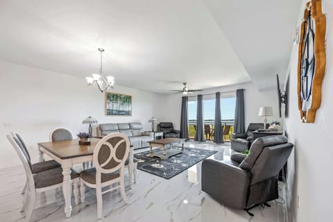 Spacious living and dining area with leather seating and balcony views.