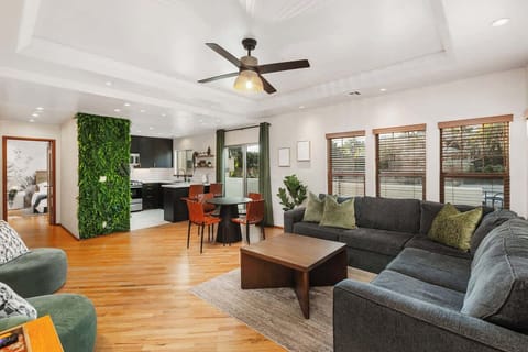 Relax in this stylish open-concept home with modern decor, a spacious living area, and a lush green accent wall. Enjoy natural light, a fully equipped kitchen, and cozy seating. Perfect for families or groups, near top attractions and dining.