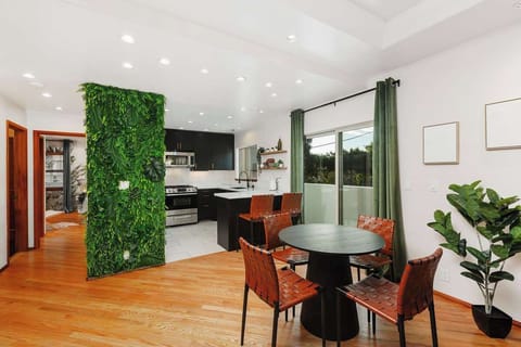 Stay in this stylish, open-concept home featuring a modern kitchen, chic dining area, and a lush green accent wall. Enjoy natural light, sleek finishes, and a private balcony. Perfect for a cozy getaway near top dining, shopping, and attractions.