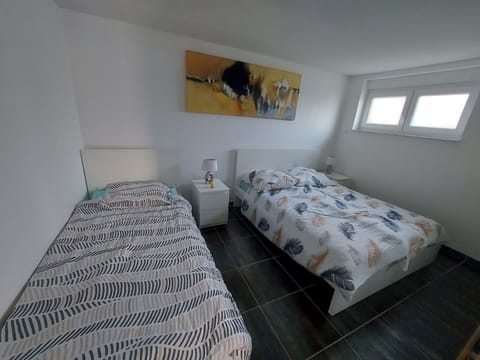 Bedroom with 1 single and 1 double bed an a big wardrobe for your clothes