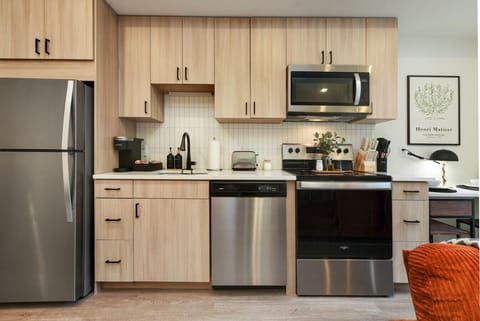 Modern kitchen cabinets with new stainless steel appliances.