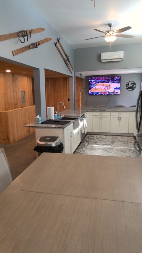 Upstairs kitchen has a 72' TV