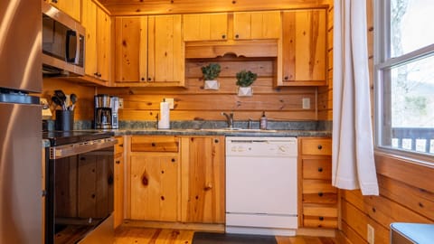 The kitchen is well-stocked with pots, pans, and cooking utensils