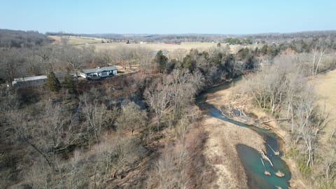 Our house situated above the War Eagle Creek. Guest house to the left.