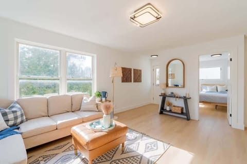 Kick back and relax in the cozy living room—plush seating, a 65” Smart TV, and a warm, inviting vibe!