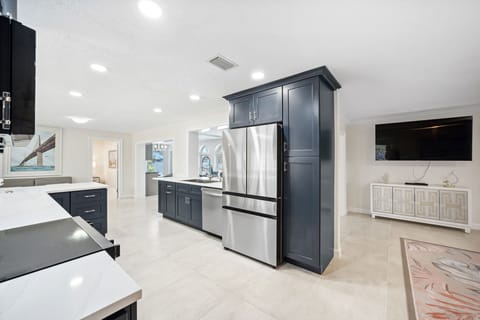 Fully-stocked kitchen with oven, microwave, fridge, dishwasher
