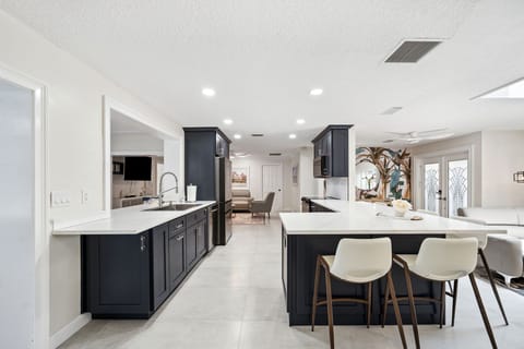 Fully-stocked kitchen with oven, microwave, fridge, dishwasher