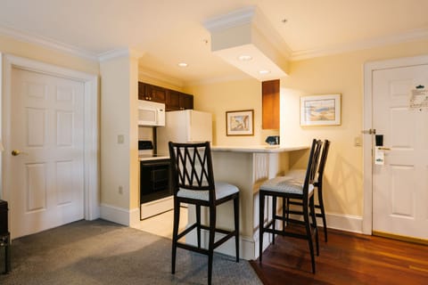 A stylish kitchenette and bar seating make this space perfect for casual dining and morning coffee.