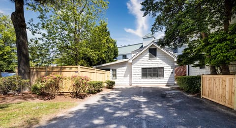 A charming exterior with lush greenery and a private driveway welcomes you to a peaceful retreat.