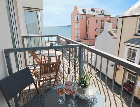 View towards the sea from the balcony with small table and chairs