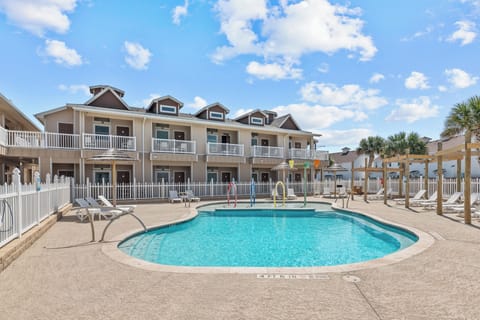 The condo unit is downstairs facing the gated pool with a splash pad