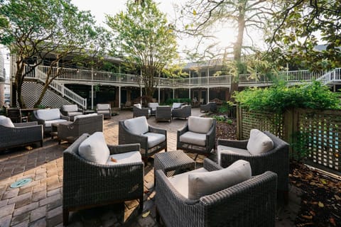 Tranquil outdoor seating surrounded by lush greenery, perfect for quiet moments or lively conversation.