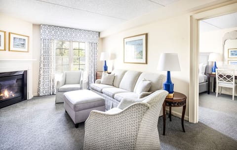 Bright and inviting living space with plush seating, a cozy fireplace, and elegant decor for a relaxing retreat.