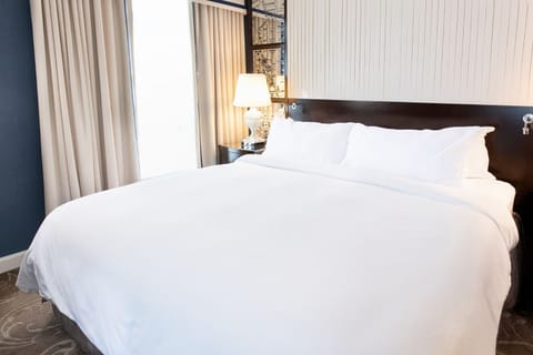 A restful retreat with modern elegance, where plush bedding and soft lighting create the perfect escape.