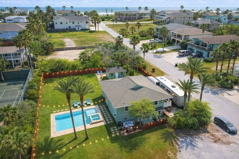 Spacious coastal retreat with private pool, connecting tub, tennis court, and lush fenced yard—perfect for family getaways or group vacations near the beach.
