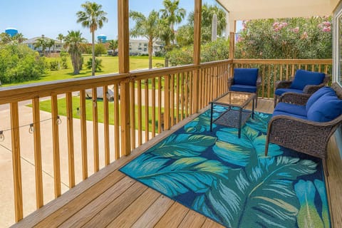 Tropical Balcony Retreat with Plush Seating & Lush Views
Unwind on a private balcony with deep-cushioned wicker seating, vibrant tropical rug, and serene palm-lined views — perfect for morning coffee or sunset wine.