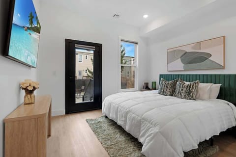 Master bedroom with access to backyard and a king size bed 