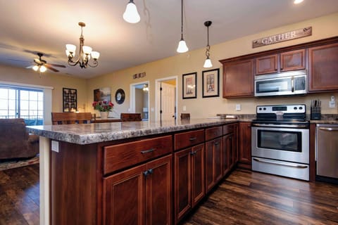 Modern kitchen features stainless steel appliances and a convenient breakfast bar—perfect for casual dining and meal prep.