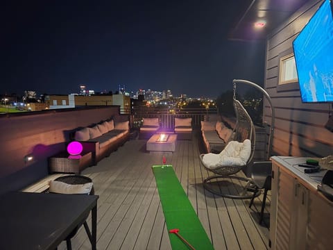 Smart TV, put golf with dual clubs and holes, large size connect 4, mini Cornhole, dining table and chairs, large seating, swing chair, storage bin for games and cushions, outdoor LED light balls, gas Fire pit