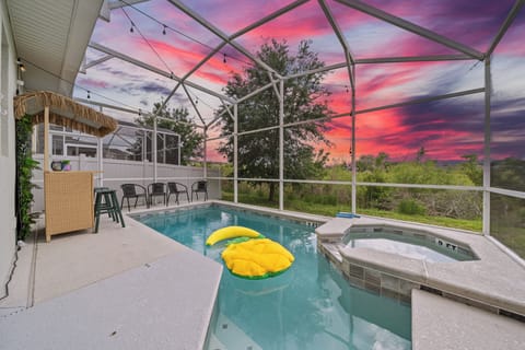 Pool in a mesh enclosure with inflatables