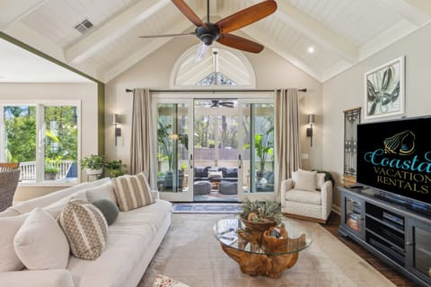 Living room with tv and beautiful outside views.