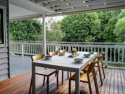 Gather with friends or family on the spacious covered deck, surrounded by lush greenery—perfect for relaxed alfresco meals.