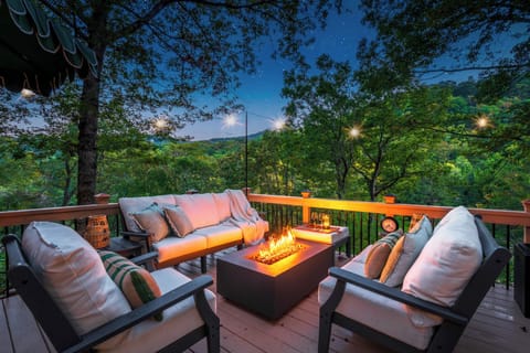 Deck: Just off the dining room, the home offers a large deck with lounge seating, fire table, outdoor dining table and an overflow bistro with umbrella, plus a grill!