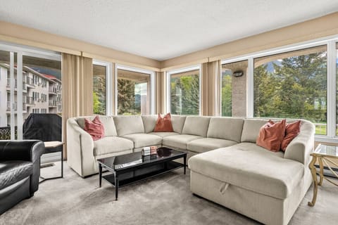 Living room with cozy seating (including an extra pull-out sleeper & bedding), Smart TV with cable, board games and a decorative fireplace.