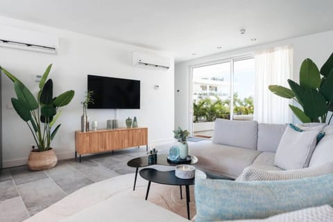 Step into your serene escape! This stylish living room, with its modern design and lush greenery, is perfect for cozy evenings or relaxing with a good book. Enjoy the calming vibes and natural light!