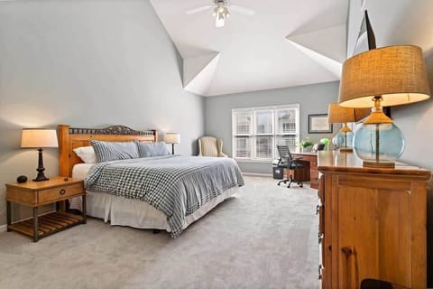 Elegant master bedroom with generous space, calming decor, and a dedicated desk area. The open layout provides both comfort and functionality for work and rest.