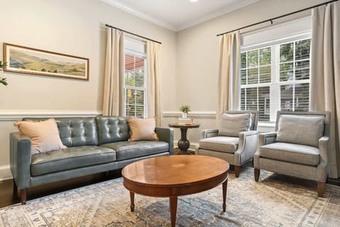 Downstairs you will find multiple areas to relax.  This photo shows the sitting room located off of the kitchen.