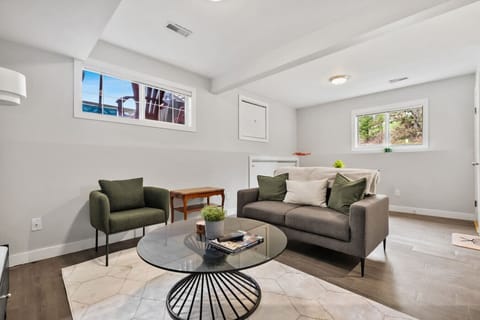 Living room with a Smart/cable TV, selection of board games & cozy seating options.