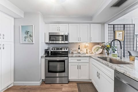 Kitchen - Fresh stainless steel appliances, farmhouse sink, dishes, essential cookware