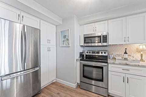 Kitchen – Featuring a sleek refrigerator with French doors and a convenient bottom freezer for easy access to all your essentials.