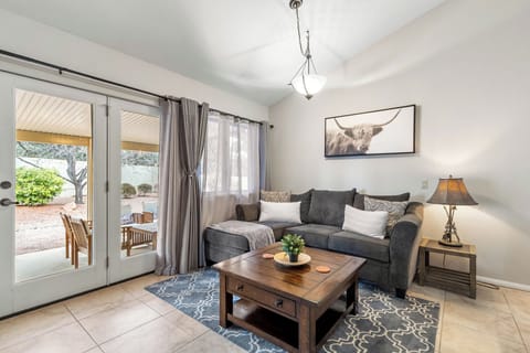 Open concept living room with direct access to the patio with a view.