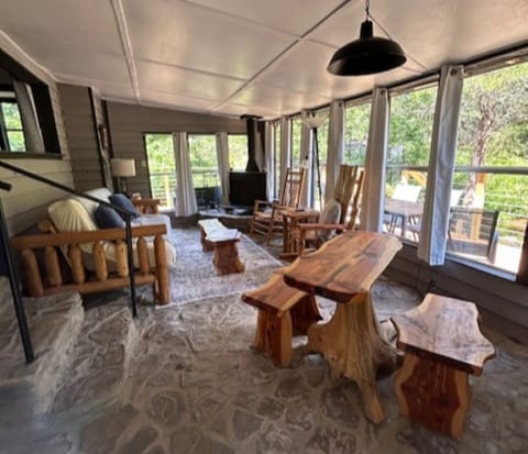 Living area with wrap around windows overlook the property.