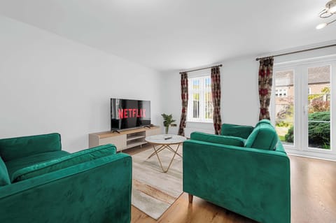 Spacious living room with comfy sofas, Smart TV, and Netflix loaded for easy evenings in