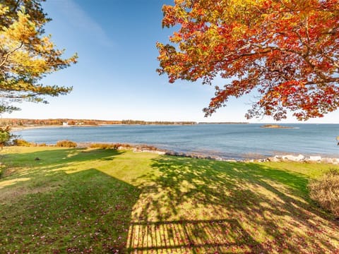 Large front lawn leading to the water