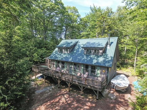 The rear of the cottage faces Coleman Pond - A screened porch has been added on the entry side of the house