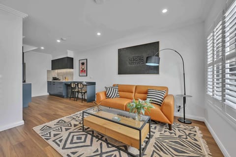 Spacious + private downstairs living area with 65" Smart TV, kitchen, and air conditioning