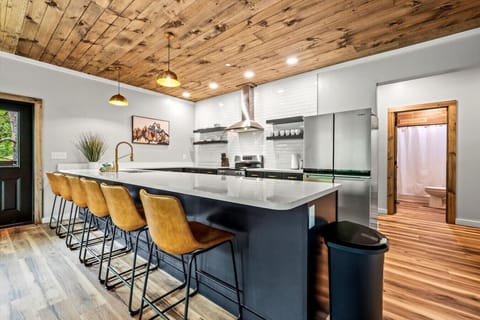 Pull up a stool and chat with the cook or gather for a late-night snack at the oversized island that anchors this inviting kitchen space.