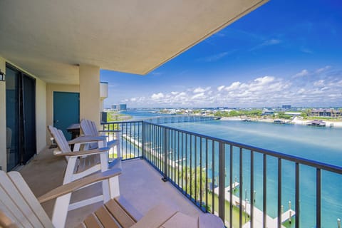 Enjoy a relaxing view of the river from this balcony with comfortable seating, perfect for unwinding after a day of adventure