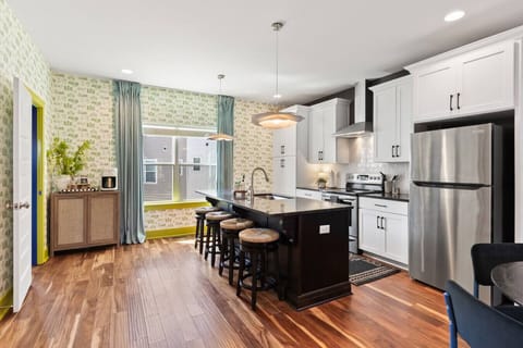 Open floor plan from the kitchen to living room, equipped with comfortable furnishings, plenty of natural light and all the kitchen essentials you would need. Seating at our dining table and the kitchen island.