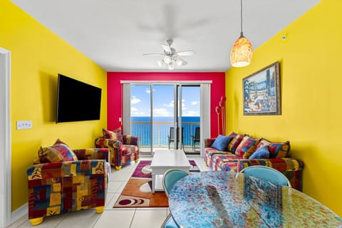 Colorful living room with ocean views and balcony access