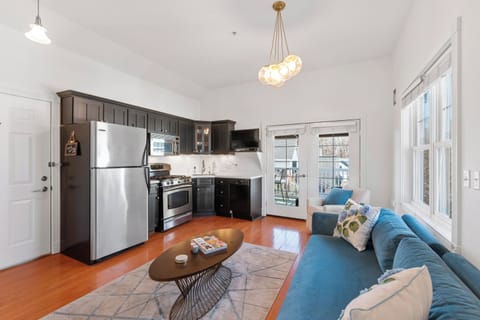 Open living & kitchen area w/ French doors leading to the porch.